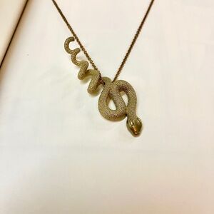 Vintage brass snake pendant snake necklace on a gold tone chain.18"